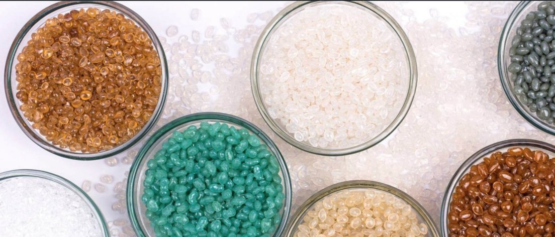 Bowls of recycled resin pellets in a range of colours and grades
